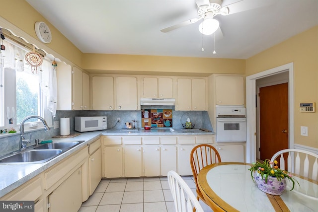 1713 Marla Pl, Vineland, NJ 08361 - kitchen with white appliances, under cabinet range hood, light tile patterned flooring, light countertops, and a sink