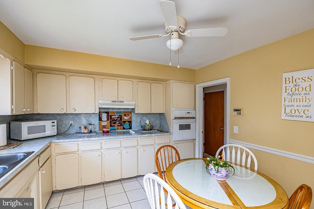 1713 Marla Pl, Vineland, NJ 08361 - kitchen with white appliances, a ceiling fan, light tile patterned flooring, under cabinet range hood, and decorative backsplash