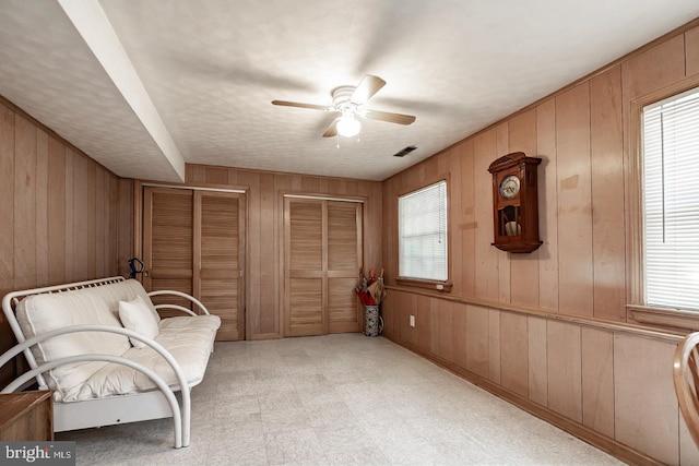 1713 Marla Pl, Vineland, NJ 08361 - sitting room featuring wooden walls, visible vents, a ceiling fan, and light floors