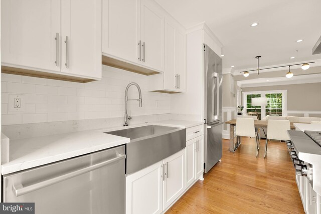 6660 Kelsey Point Cir, Alexandria, VA 22315 - kitchen with appliances with stainless steel finishes, white cabinetry, open floor plan, tasteful backsplash, and light wood-style flooring