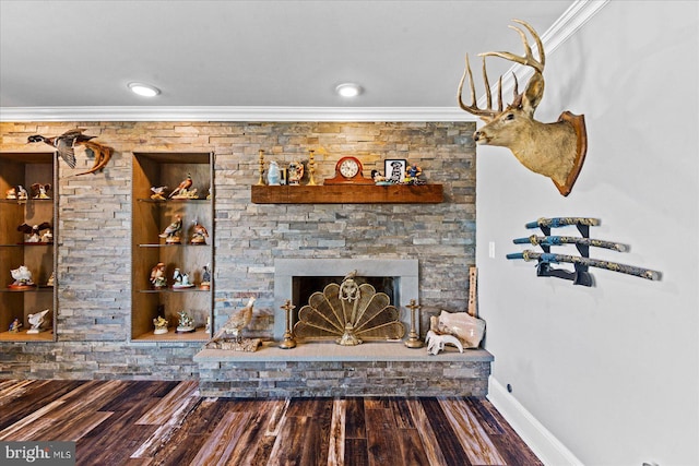 living room featuring a stone fireplace, ornamental molding, wood finished floors, and baseboards