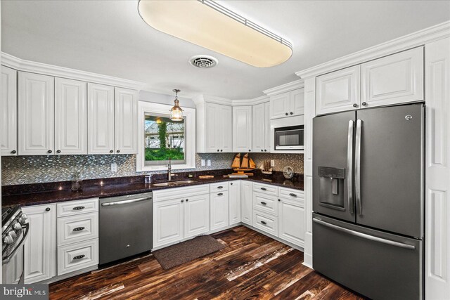 kitchen featuring white cabinets, appliances with stainless steel finishes, a sink, and visible vents
