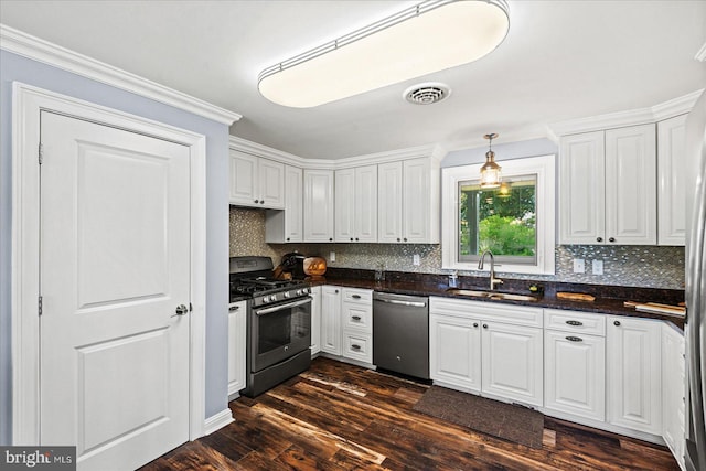 kitchen featuring white cabinets, backsplash, stainless steel appliances, and a sink