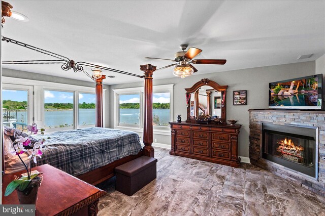 bedroom featuring access to exterior, baseboards, visible vents, marble finish floor, and a stone fireplace