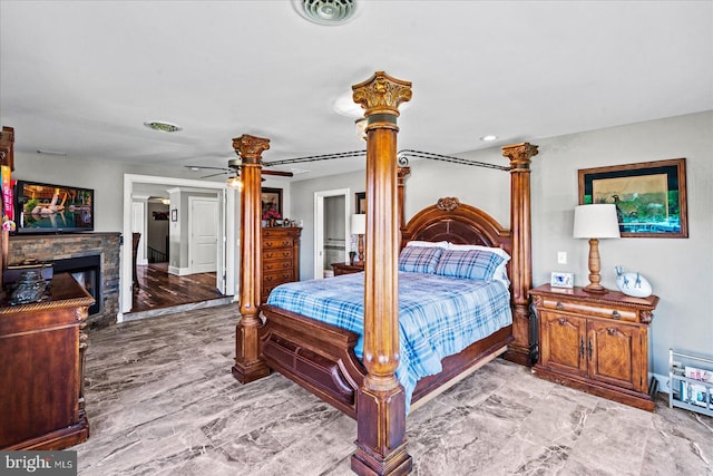 bedroom with a stone fireplace and visible vents