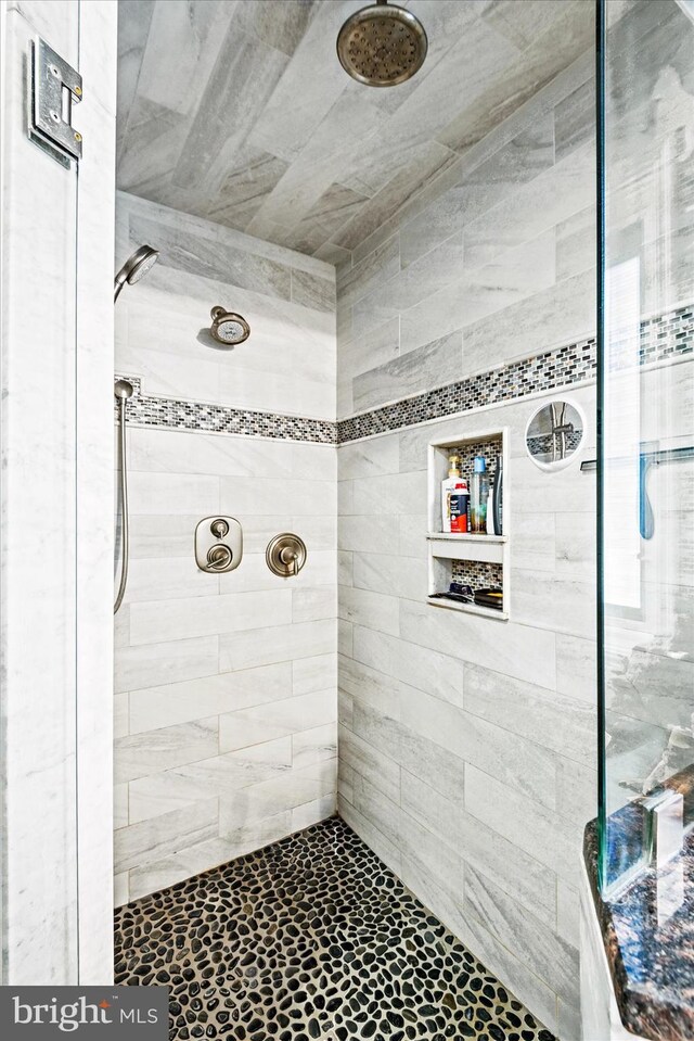 full bath with a tile shower