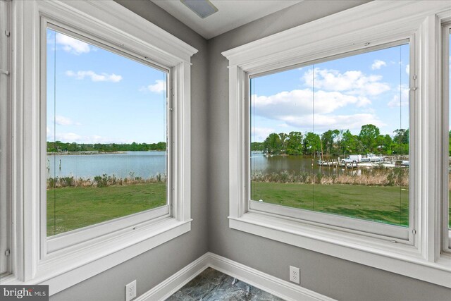 details featuring a water view and baseboards