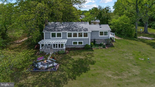 back of house with a pergola, a yard, and a chimney