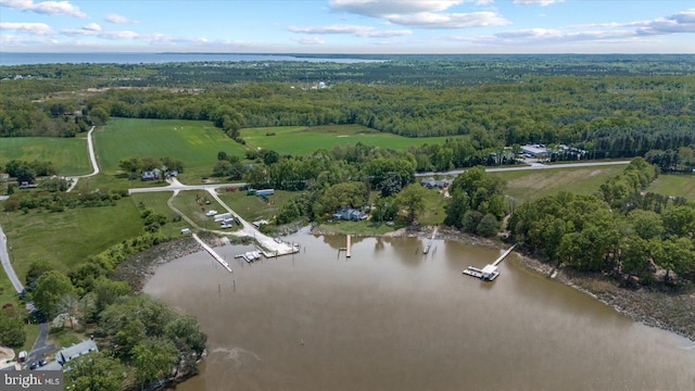 aerial view with a wooded view and a water view