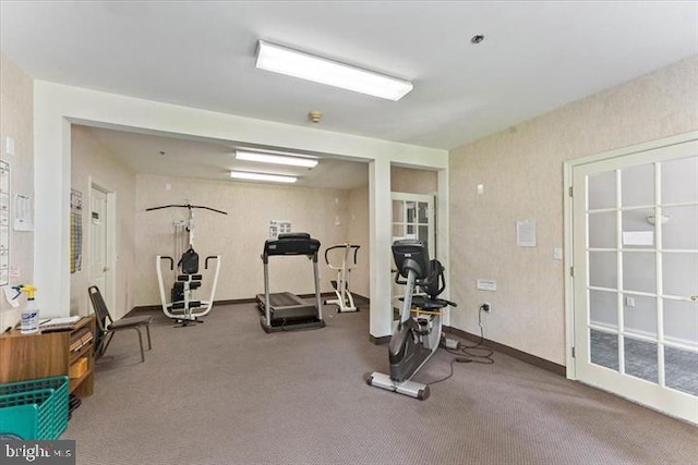 workout room with carpet floors and baseboards