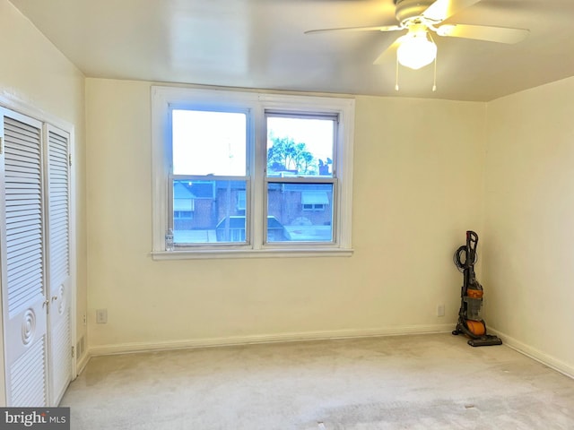 unfurnished bedroom featuring a closet, baseboards, a ceiling fan, and carpet flooring