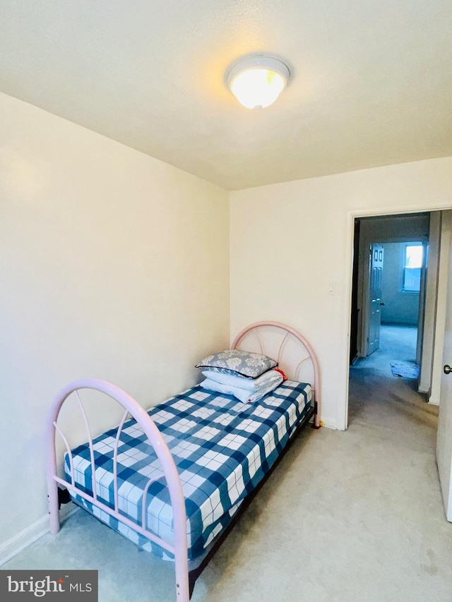 bedroom featuring baseboards and carpet flooring