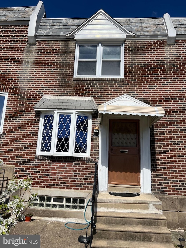 property entrance with brick siding