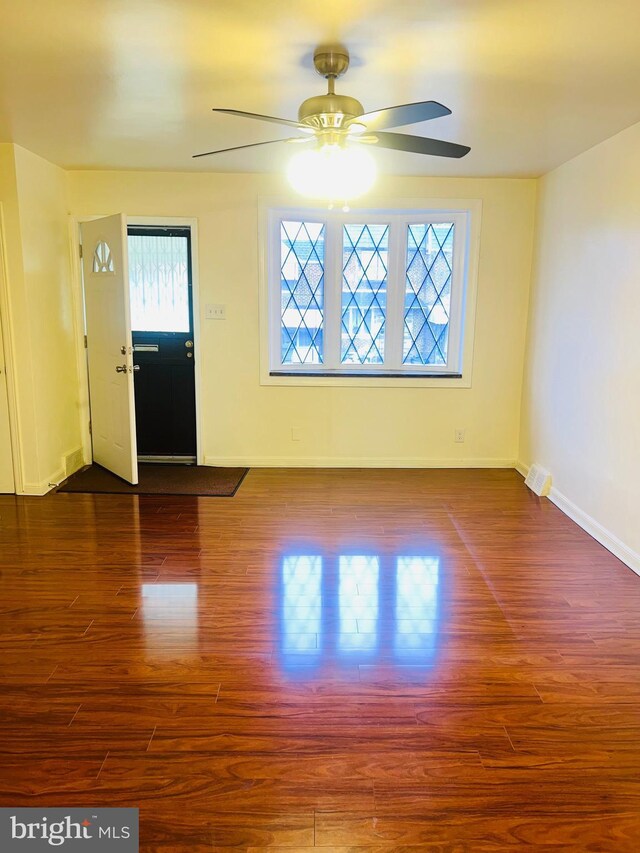 entryway with baseboards, wood finished floors, and ceiling fan