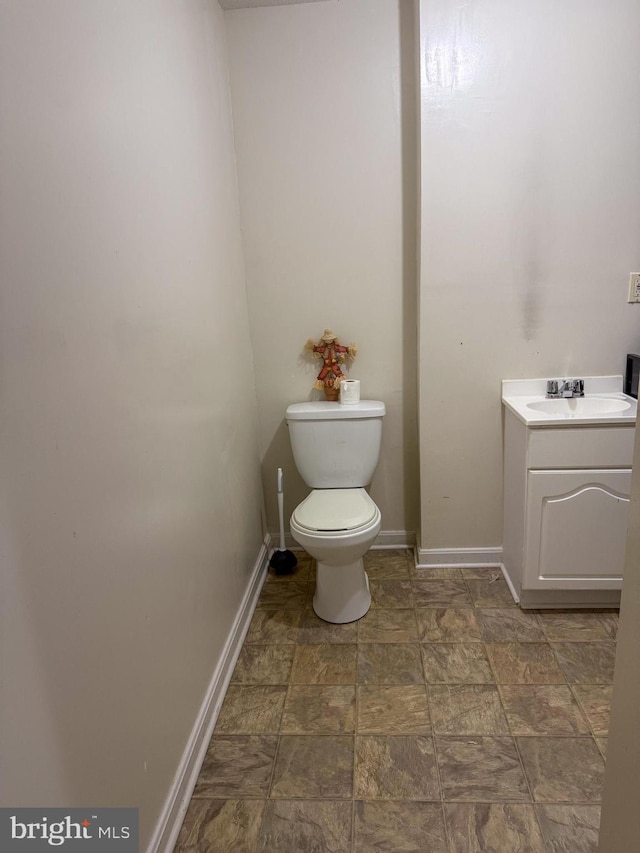 10861 Smugglers Notch Ct, White Plains, MD 20695 - half bathroom with toilet, baseboards, stone finish flooring, and vanity