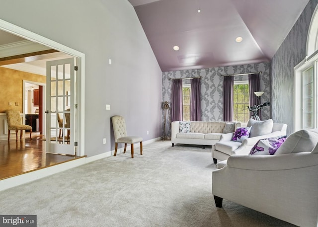 living area featuring wallpapered walls, vaulted ceiling, carpet flooring, and french doors