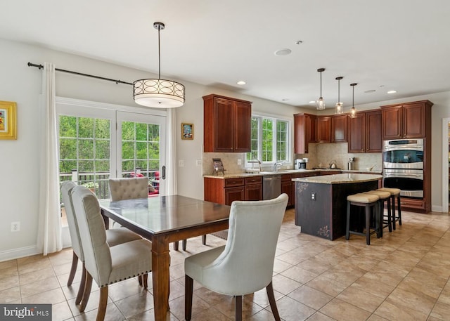 dining area with recessed lighting, baseboards, and light tile patterned floors