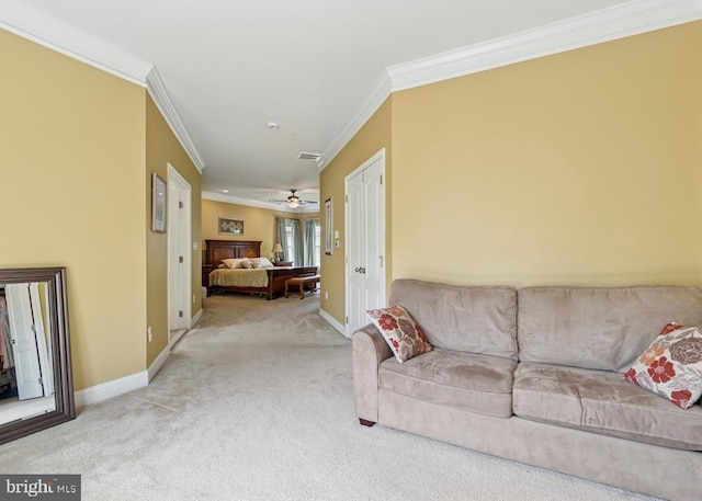 living area featuring a ceiling fan, baseboards, carpet floors, and ornamental molding