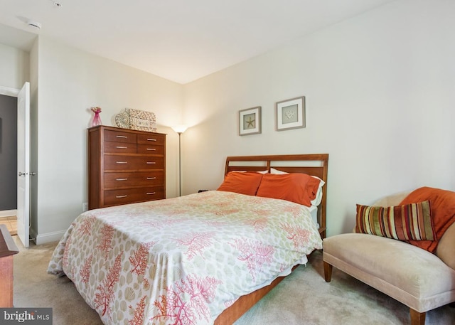 bedroom with baseboards and carpet flooring