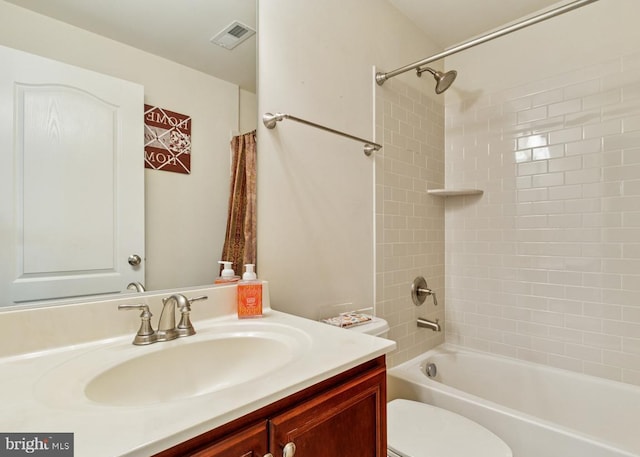 full bathroom with shower / bathing tub combination, visible vents, vanity, and toilet