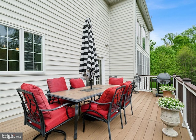 wooden terrace with outdoor dining space