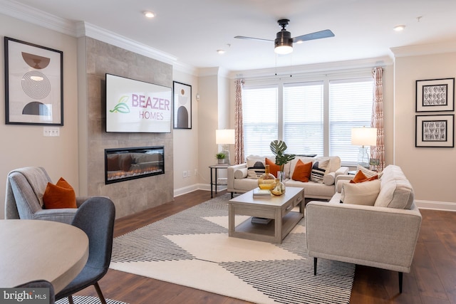 living area featuring baseboards, ornamental molding, a ceiling fan, and dark wood-style floors