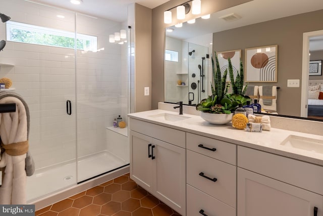 bathroom featuring a sink, tile patterned floors, a shower stall, and visible vents