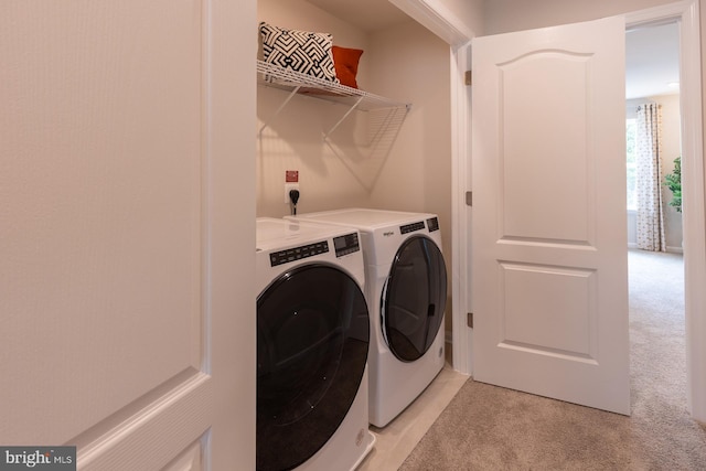 laundry room with light colored carpet, laundry area, and washer and clothes dryer