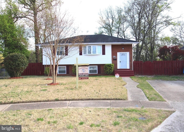 2214 Wintergreen Ave, District Heights, MD 20747 - split foyer home featuring a front yard, fence, and brick siding