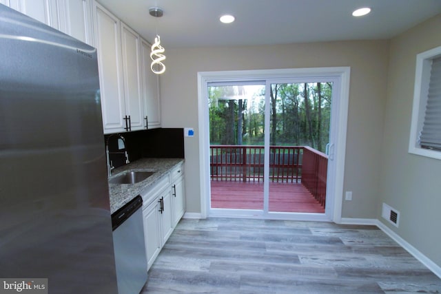 2214 Wintergreen Ave, District Heights, MD 20747 - kitchen featuring light stone countertops, white cabinetry, visible vents, recessed lighting, and appliances with stainless steel finishes