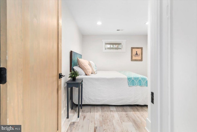 bedroom with recessed lighting, visible vents, and wood finished floors