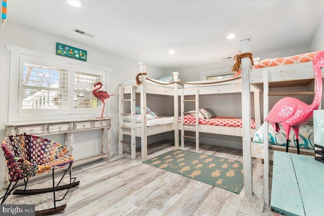 bedroom featuring wood finished floors, visible vents, and recessed lighting