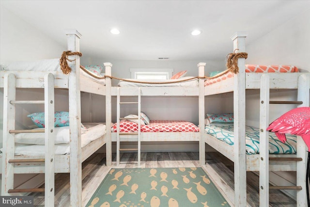 bedroom featuring wood finished floors and recessed lighting