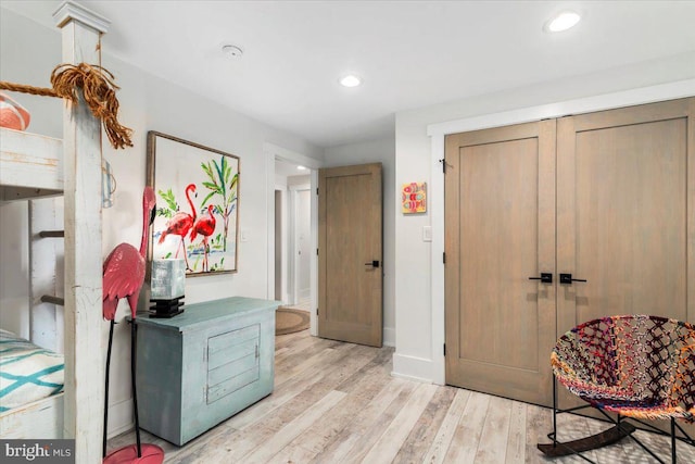 interior space with light wood-type flooring, baseboards, and recessed lighting