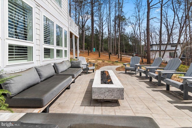 view of patio / terrace with an outdoor living space with a fire pit