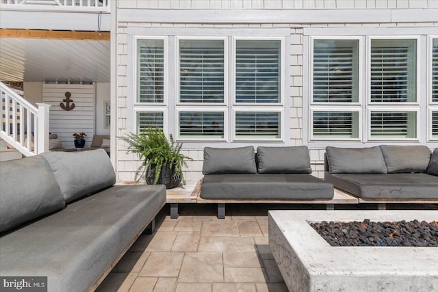 view of patio / terrace featuring an outdoor living space with a fire pit