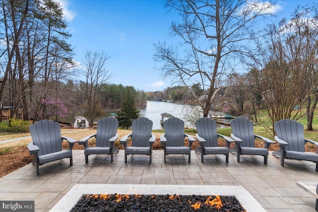 view of patio / terrace with a water view and a fire pit