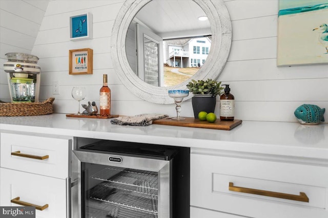 bar featuring wooden walls and beverage cooler