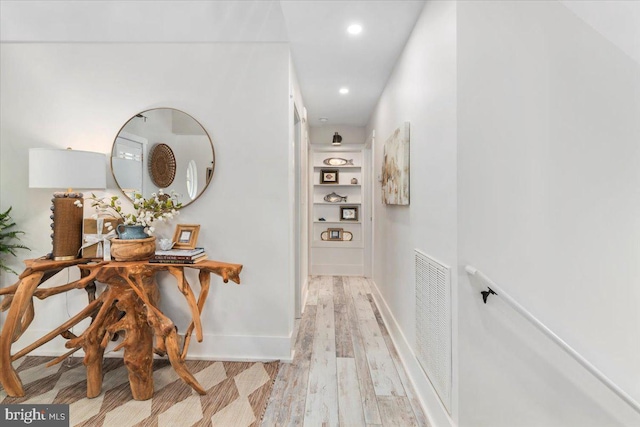 corridor with visible vents, baseboards, light wood-type flooring, and recessed lighting