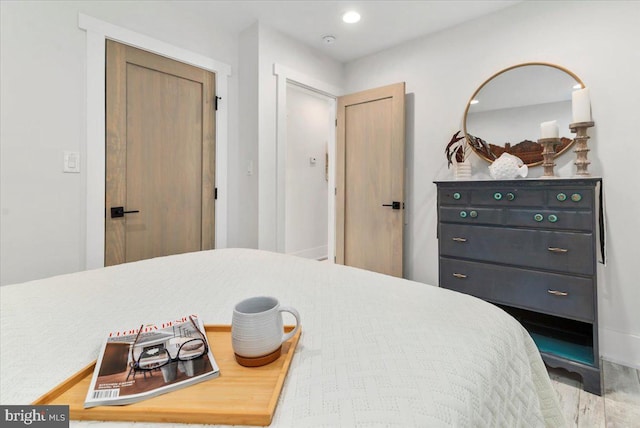 bedroom with recessed lighting and wood finished floors