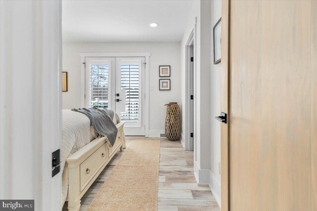 interior space with light wood-style flooring, french doors, baseboards, and recessed lighting