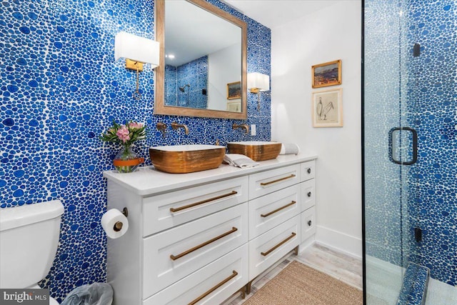 full bath with toilet, a stall shower, and vanity
