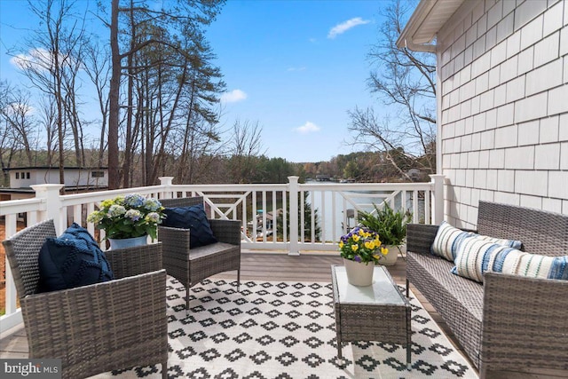 wooden deck featuring an outdoor hangout area