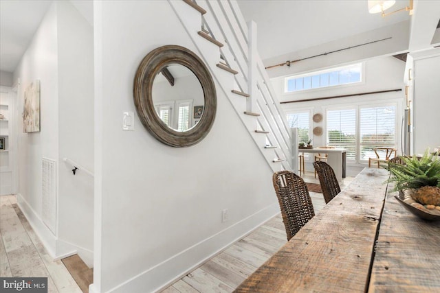 interior space featuring light wood finished floors, visible vents, and baseboards
