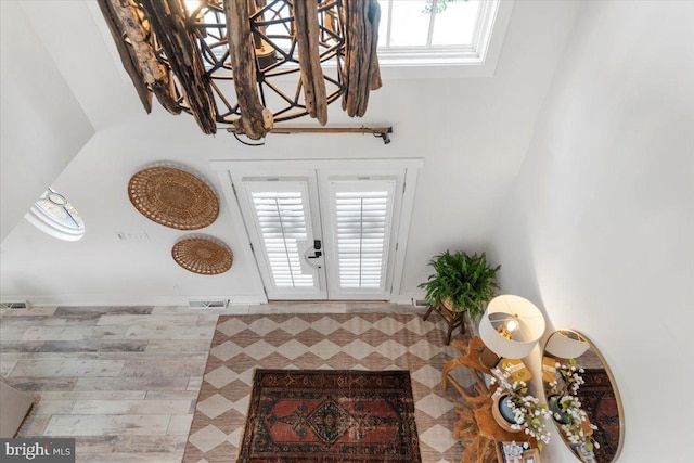 foyer entrance with french doors, a healthy amount of sunlight, and visible vents
