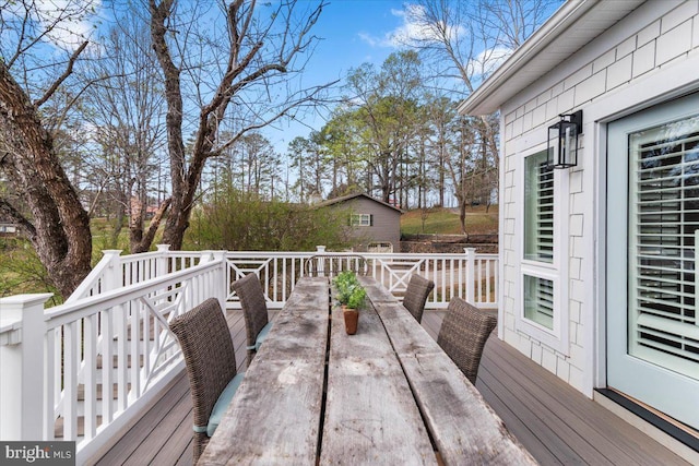 wooden terrace with outdoor dining area