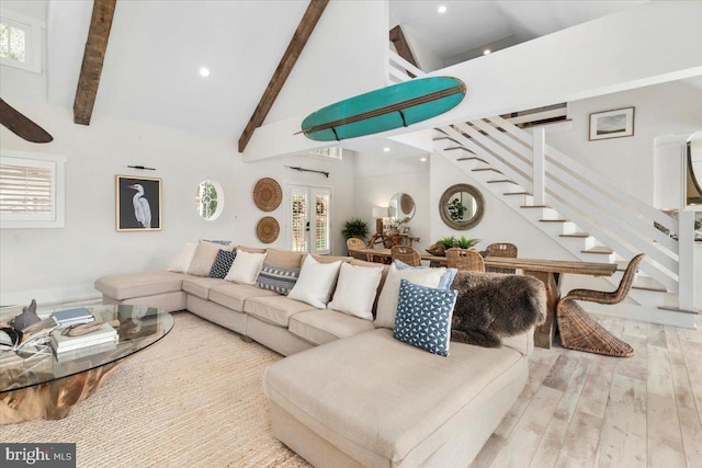 living room with beamed ceiling, recessed lighting, stairway, wood finished floors, and high vaulted ceiling