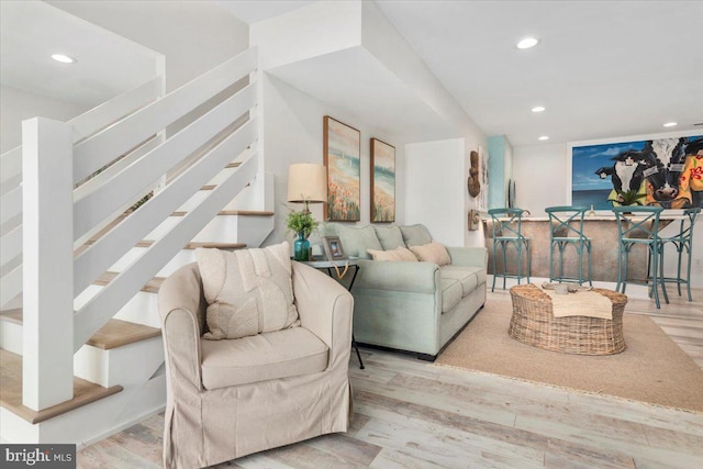 living room with recessed lighting, stairway, and wood finished floors