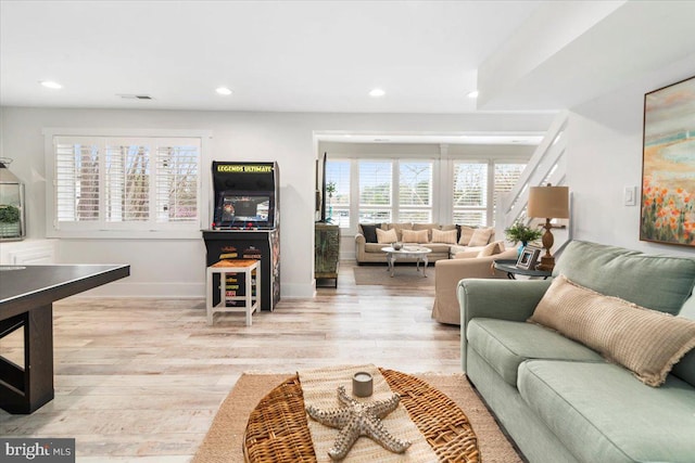 living room featuring wood finished floors, baseboards, and recessed lighting