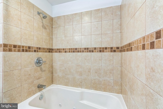 bathroom with a combined bath / shower with jetted tub